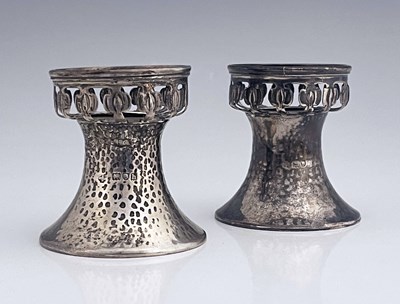 Lot 96 - A pair of Arts and Crafts silver pedestal salt...