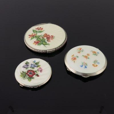 Lot 205 - Three silver circular powder compacts, in...