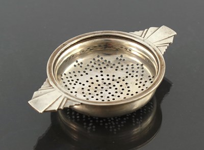 Lot 288 - An Art Deco silver tea strainer, Walker and...