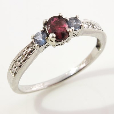 Lot 303 - A 9ct gold ruby and tanzanite three-stone...