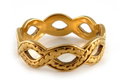 Lot 307 - A 22ct gold openwork band ring, of engraved...
