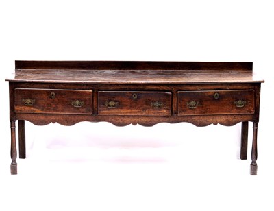 Lot 344 - An 18th Century country oak standing dresser,...