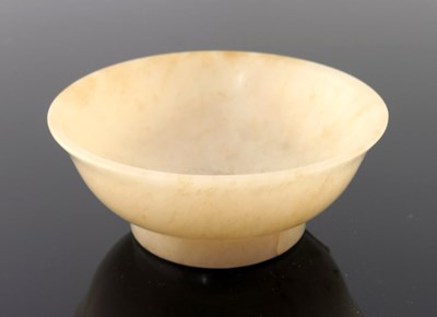 Lot 468 - A Chinese pale jade small bowl, gently everted...