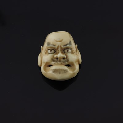 Lot 500 - ? A Japanese ivory miniature face mask, Meiji...