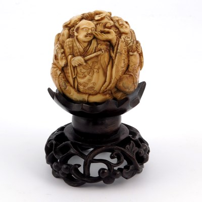 Lot 527 - ? A 19th century Japanese carved ivory ball,...