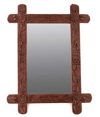 Lot 637 - An Arts and Crafts carved oak wall mirror,...