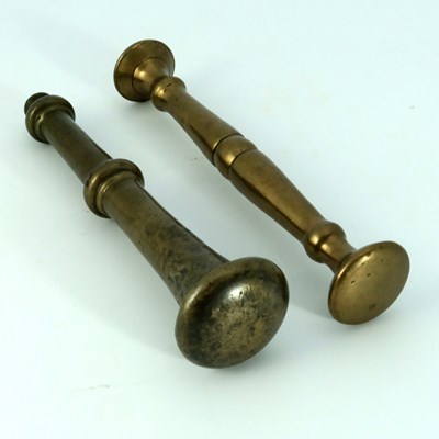 Lot 668 - Two 17th century bronze pestles, 21cm long (2)