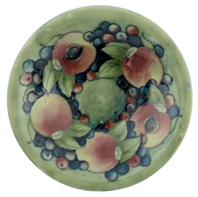 Lot 951 - William Moorcroft, a Pomegranate on celadon...