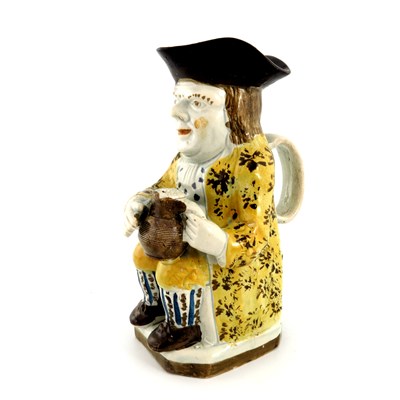 Lot 1119 - A pearlware Toby jug, circa 1800 of...
