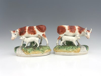 Lot 1059 - A pair of Staffordshire cows with calves,...