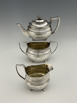 Lot 446 - A George III matched silver three-piece tea...