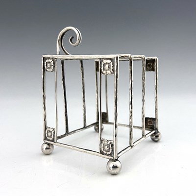 Lot 93 - A E Jones, an Arts and Crafts silver three...