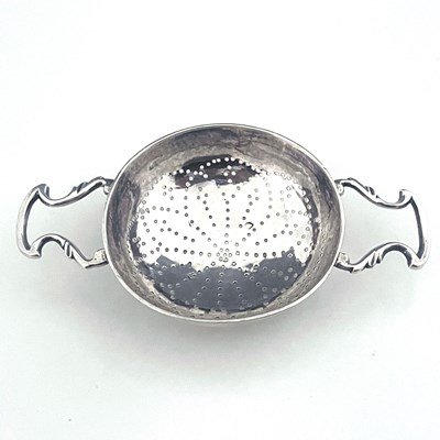 Lot 157 - A George II silver lemon strainer, the rounded...