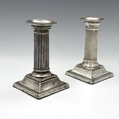 Lot 132 - A pair of George V silver candlesticks, with...