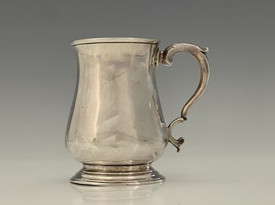 Lot 96 - An early George III silver mug, of baluster...