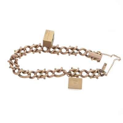 Lot 115 - An early 20th century 9ct gold curb-link bracelet, with charms