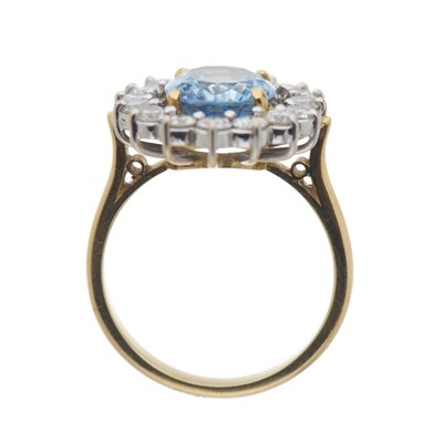 Lot 32 - An 18ct gold aquamarine and diamond cluster ring