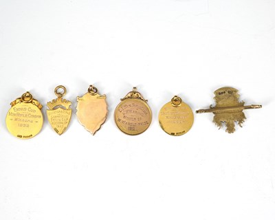Lot 18 - Five 9ct gold medallions, including rifle...