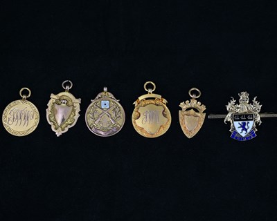 Lot 18 - Five 9ct gold medallions, including rifle...