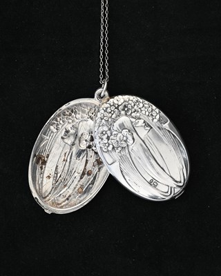 Lot 34 - An Art Nouveau silver locket pendant, import...