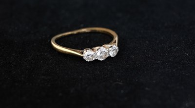 Lot 2 - An 18 carat gold three stone diamond ring,...
