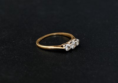 Lot 2 - An 18 carat gold three stone diamond ring,...