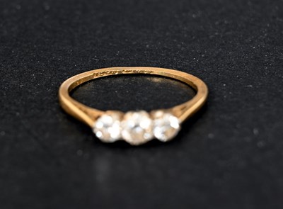 Lot 2 - An 18 carat gold three stone diamond ring,...