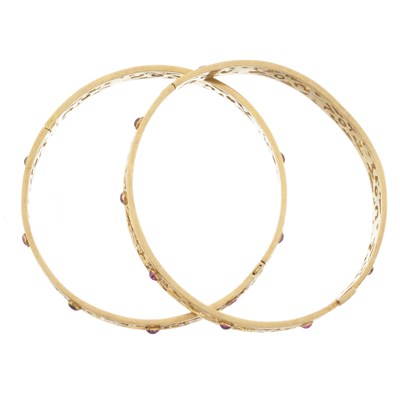 Lot 49 - Two gold pink gem foliate openwork bangle bracelets