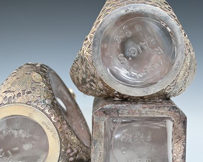 Lot 30 - China. Three Chinese silver overlay decanters,...