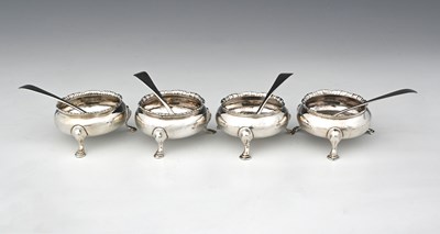 Lot 322 - A matched set of four George III silver salt...
