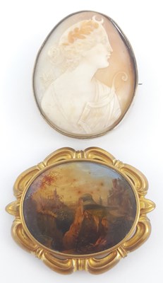 Lot 227 - A Victorian pinchbeck brooch, with an oval painting on copper, and an oval shell cameo brooch