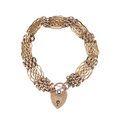 Lot 12 - An early 20th century 9ct gold gate bracelet,...