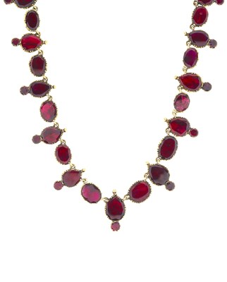 Lot 35 - A late Georgian gold, foil back garnet riviere...