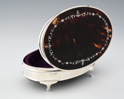 Lot 320 - A George V silver dressing table box, of oval...
