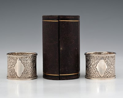 Lot 287 - A cased pair of Victorian silver napkin rings,...
