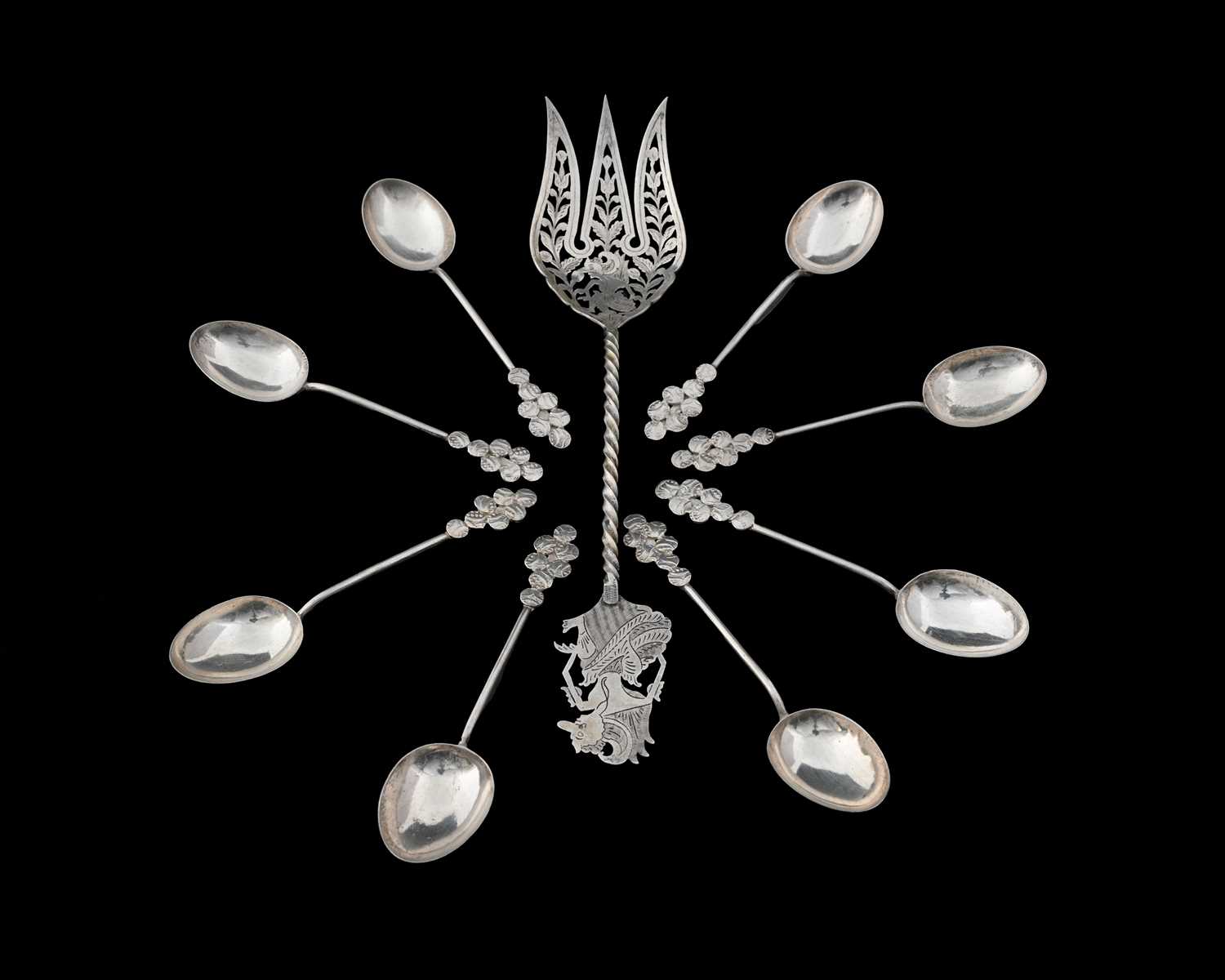 Lot 9 - A set of eight Eastern silver-coloured metal...