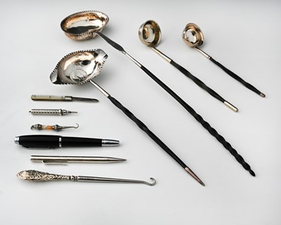 Lot 80 - Four ladles, each with a silver-coloured metal...