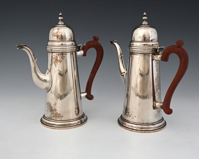 Lot 326 - A pair of Elizabeth II silver coffee pots,...