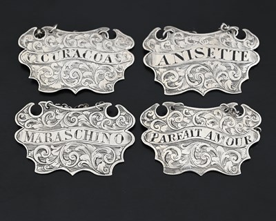 Lot 197 - A set of four Victorian silver wine labels or...