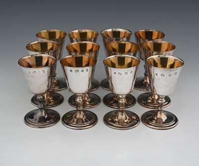Lot 107 - A set of twelve Elizabeth II silver goblets,...