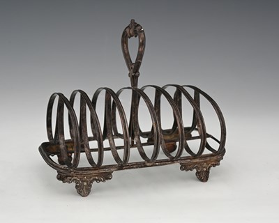 Lot 167 - A Victorian silver toast rack, atop four cast...