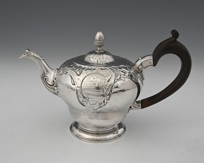 Lot 415 - A George II silver teapot, the upper body...