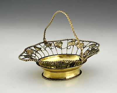 Lot 272 - An early George III silver-gilt swing handle...