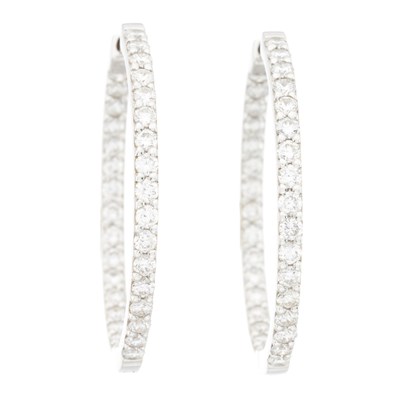 Lot 60 - A pair of 18ct gold diamond hoop earrings