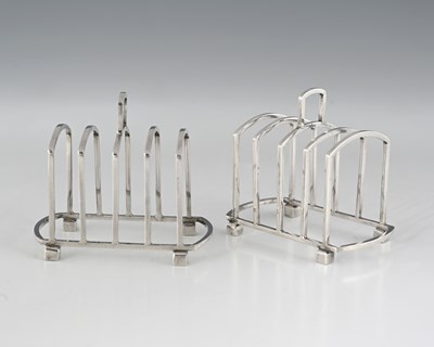 Lot 509 - A pair of Art Deco silver six-bar toast racks,...