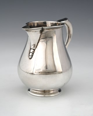 Lot 83 - A George V silver sparrow beak cream pitcher...