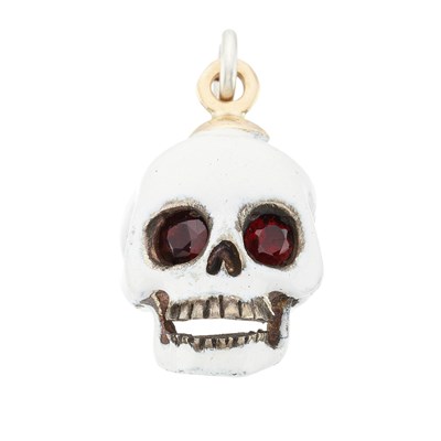 Lot 113 - A silver and gold, white enamel and garnet memento mori skull pendant