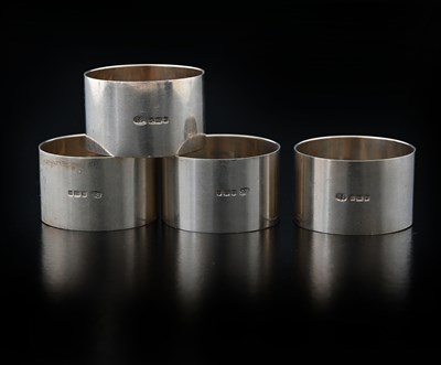 Lot 87 - A set of four George V silver napkin rings,...
