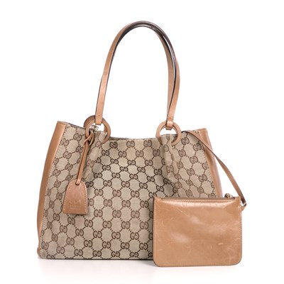 Lot 311 - Gucci, a monogram handbag with pouch, crafted...