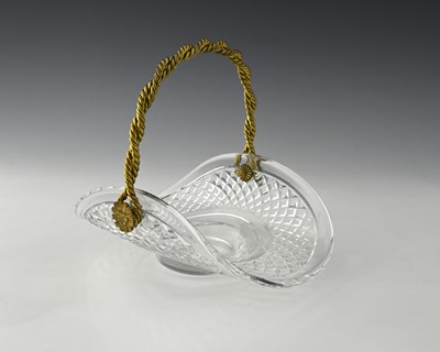 Lot 477 - A gilt metal and cut glass basket, the body of...